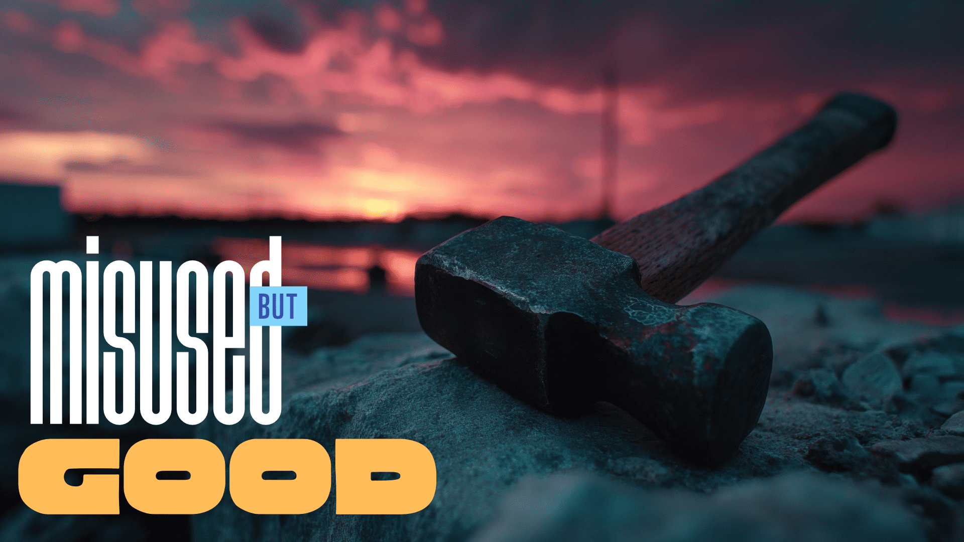 Hammer resting on wood with a vibrant sunset background.