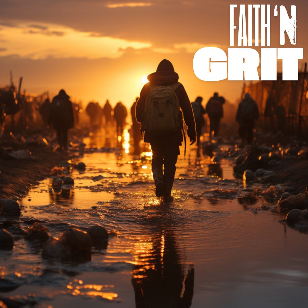 Silhouetted person with backpack walking at sunset